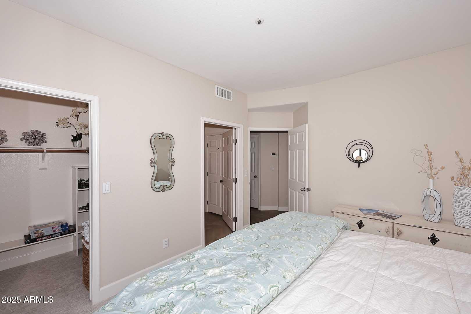 7700 East Gainey Ranch Road, Unit 128 Scottsdale, AZ 85258 - Photo 30 of 60 a bedroom with a bed and a cabinets