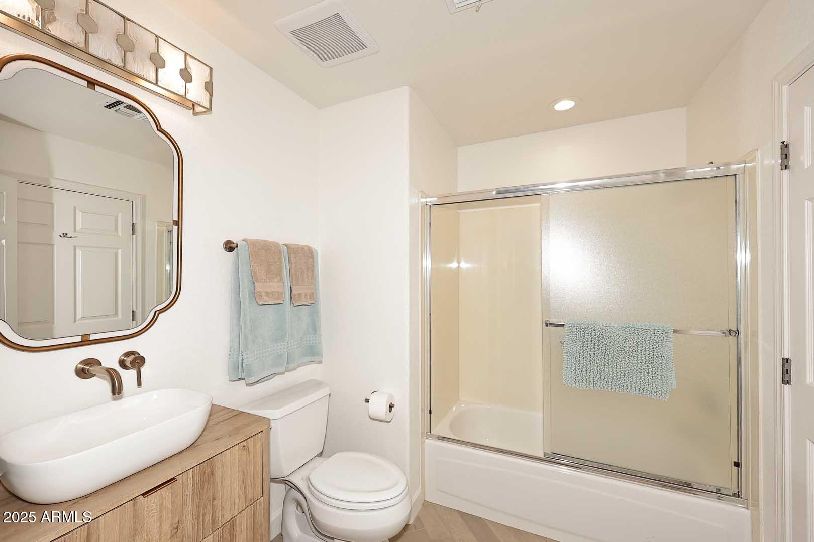 7700 East Gainey Ranch Road, Unit 128 Scottsdale, AZ 85258 - Photo 31 of 60 a bathroom with a sink a toilet and shower