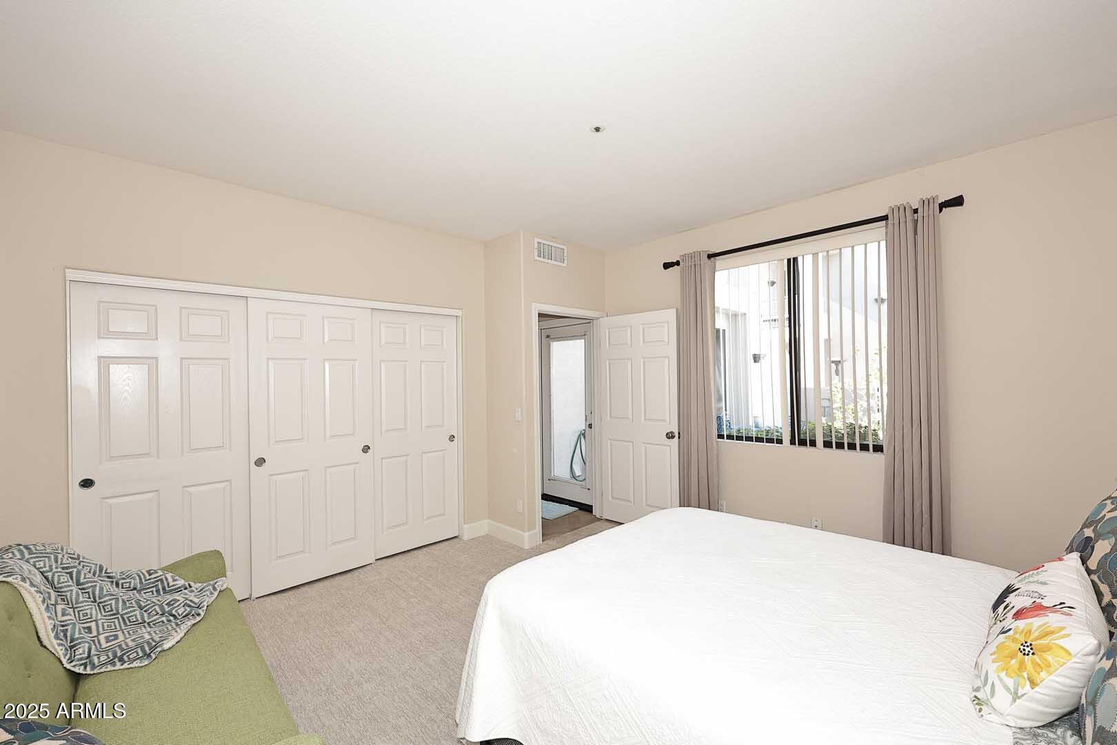 7700 East Gainey Ranch Road, Unit 128 Scottsdale, AZ 85258 - Photo 33 of 60 a bedroom with a bed and a window