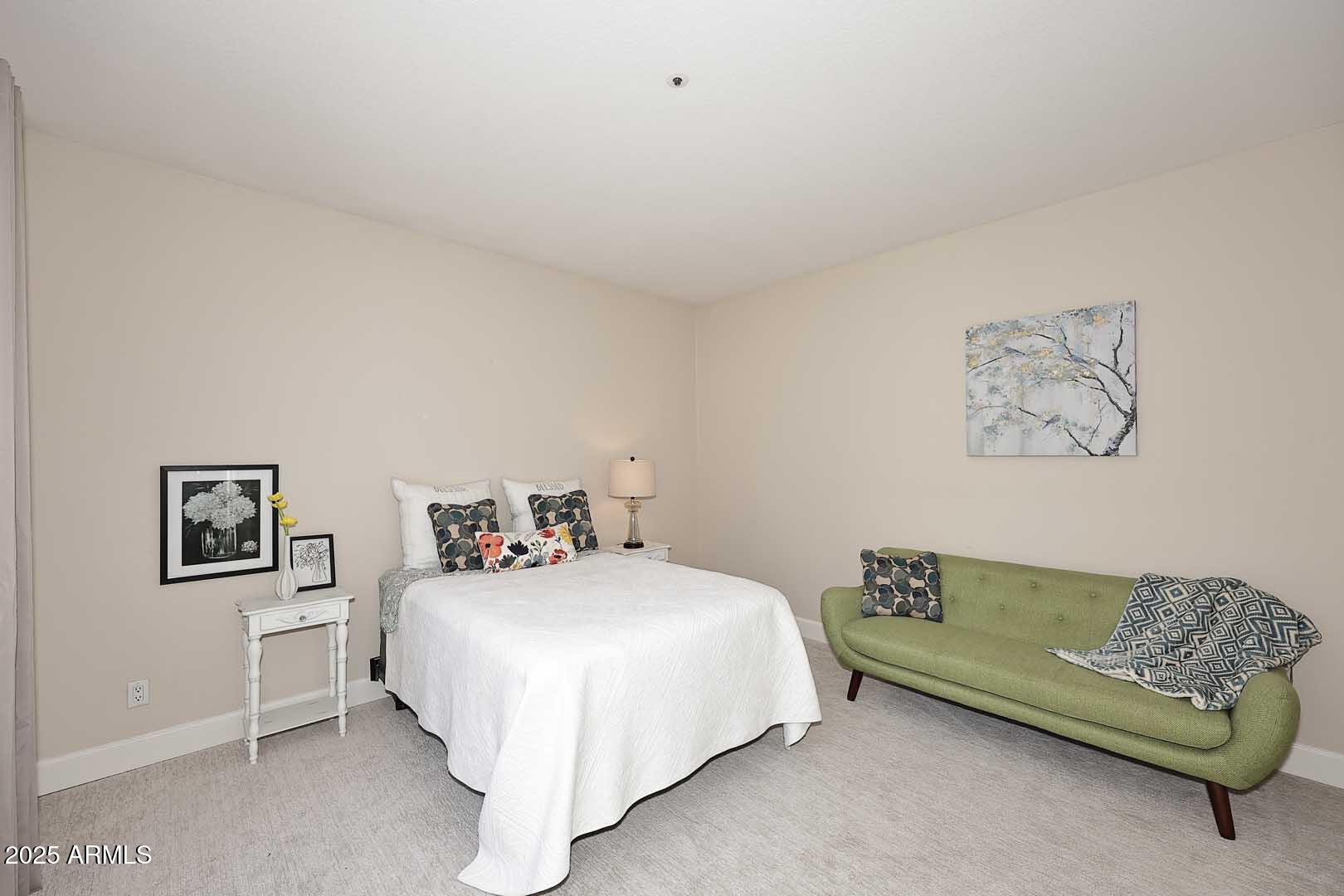 7700 East Gainey Ranch Road, Unit 128 Scottsdale, AZ 85258 - Photo 34 of 60 a bedroom with a bed and a couch