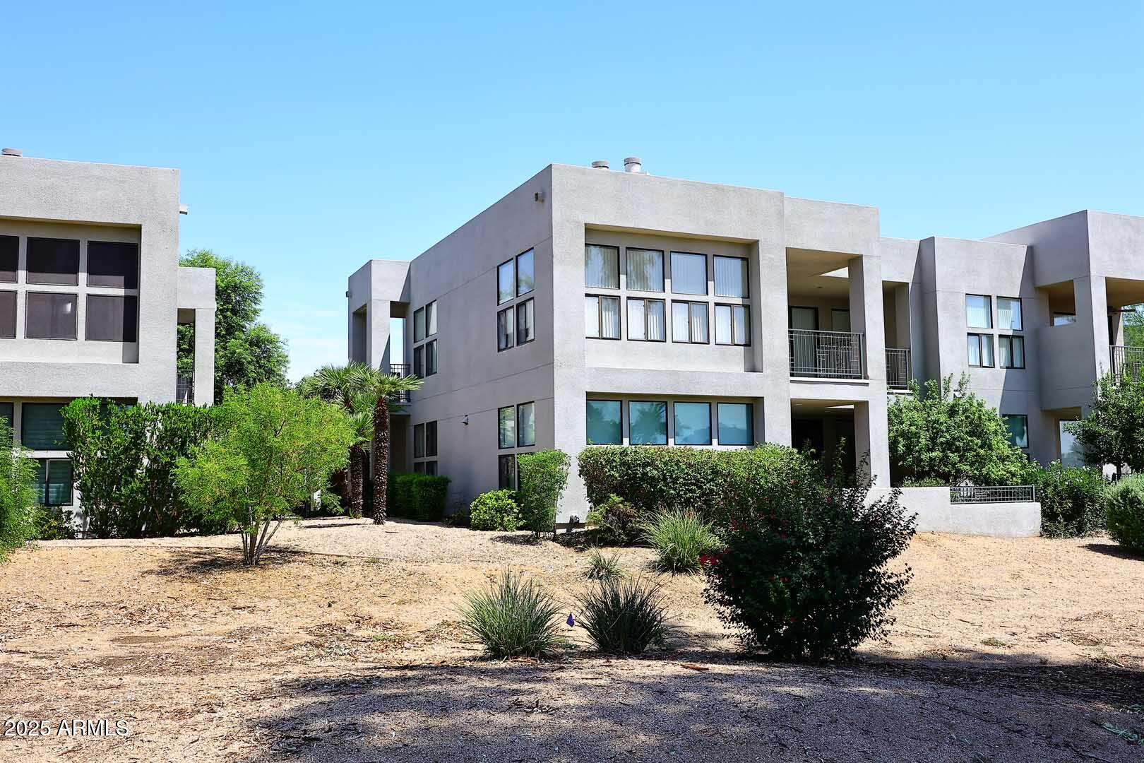 7700 East Gainey Ranch Road, Unit 128 Scottsdale, AZ 85258 - Photo 37 of 60 a view of a building with a yard