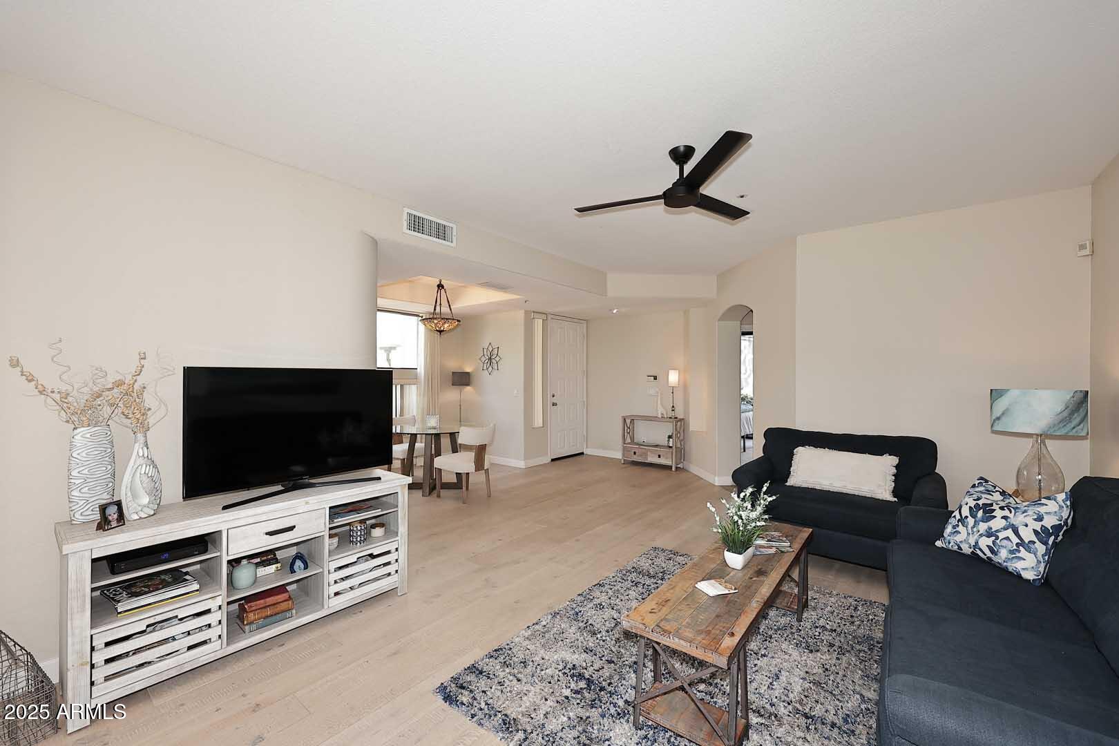7700 East Gainey Ranch Road, Unit 128 Scottsdale, AZ 85258 - Photo 40 of 60 a living room with furniture and a flat screen tv