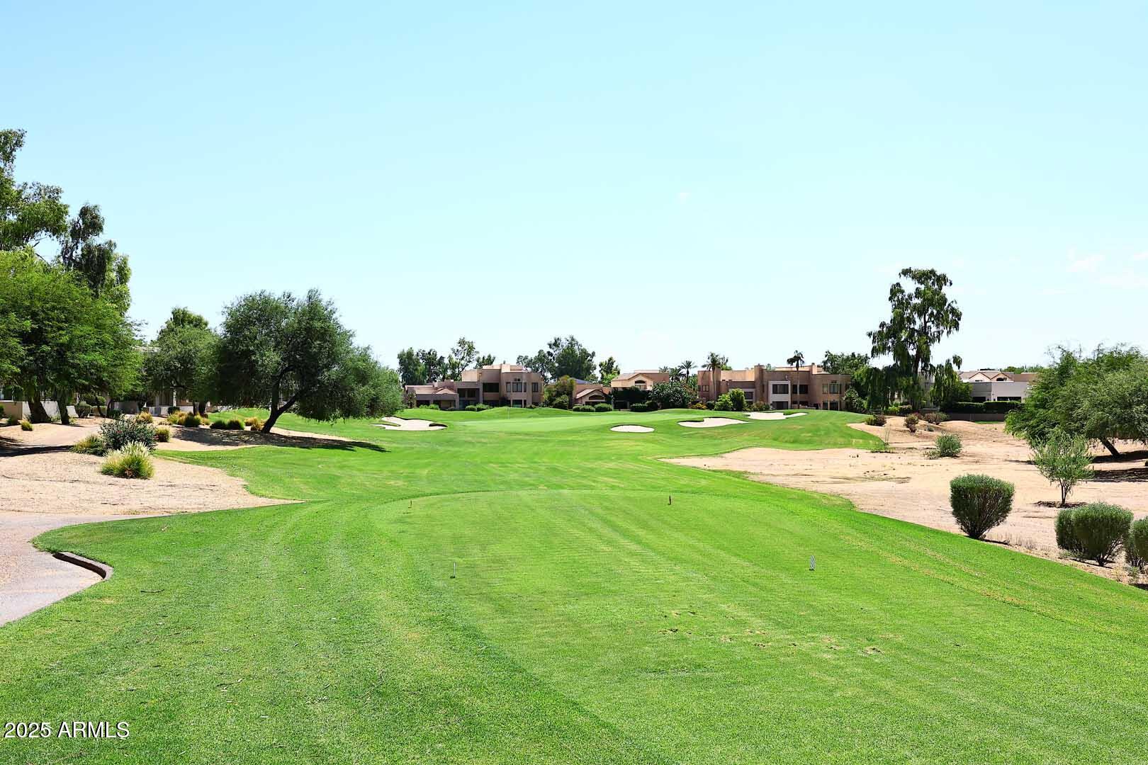 7700 East Gainey Ranch Road, Unit 128 Scottsdale, AZ 85258 - Photo 4 of 60 a view of a swimming pool with a yard