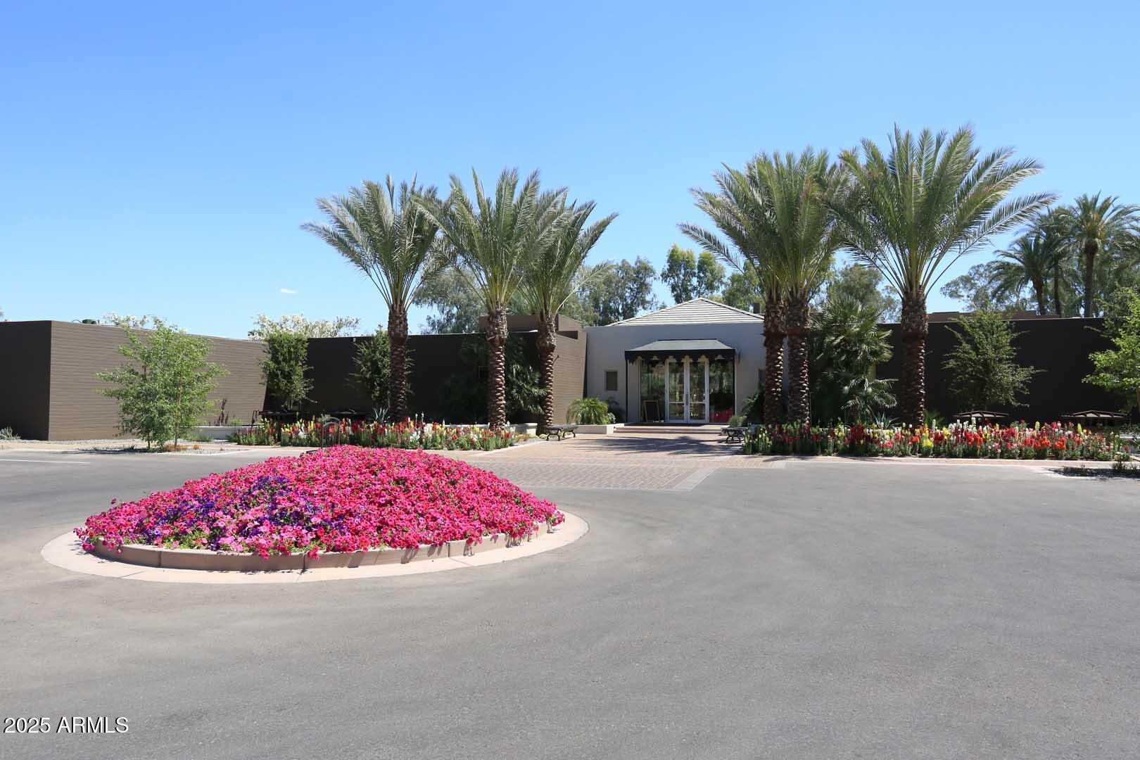 7700 East Gainey Ranch Road, Unit 128 Scottsdale, AZ 85258 - Photo 48 of 60 front view of a house with a yard and a garage