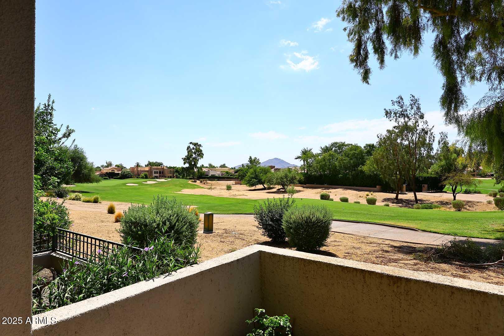 7700 East Gainey Ranch Road, Unit 128 Scottsdale, AZ 85258 - Photo 5 of 60 a view of a lake with a yard and potted plants