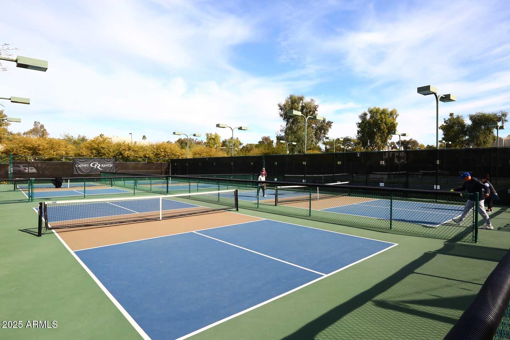 7700 East Gainey Ranch Road, Unit 128 Scottsdale, AZ 85258 - Photo 51 of 60 a view of tennis court with houses
