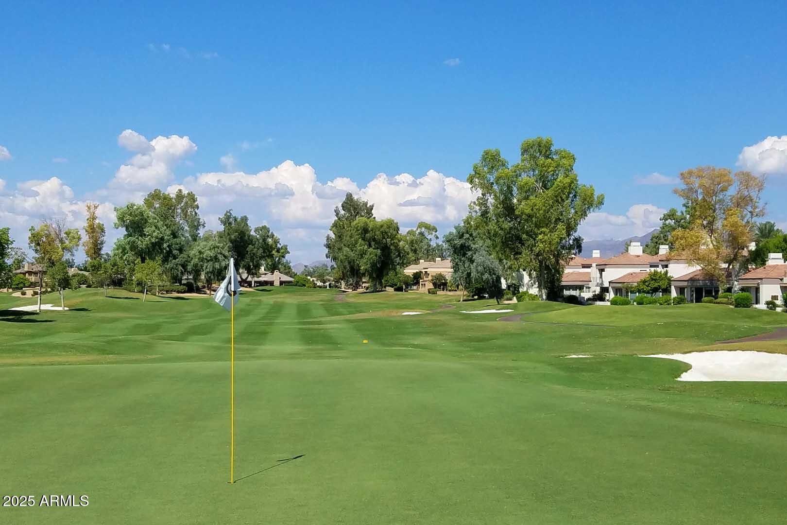 7700 East Gainey Ranch Road, Unit 128 Scottsdale, AZ 85258 - Photo 60 of 60 a front view of a house with a big yard