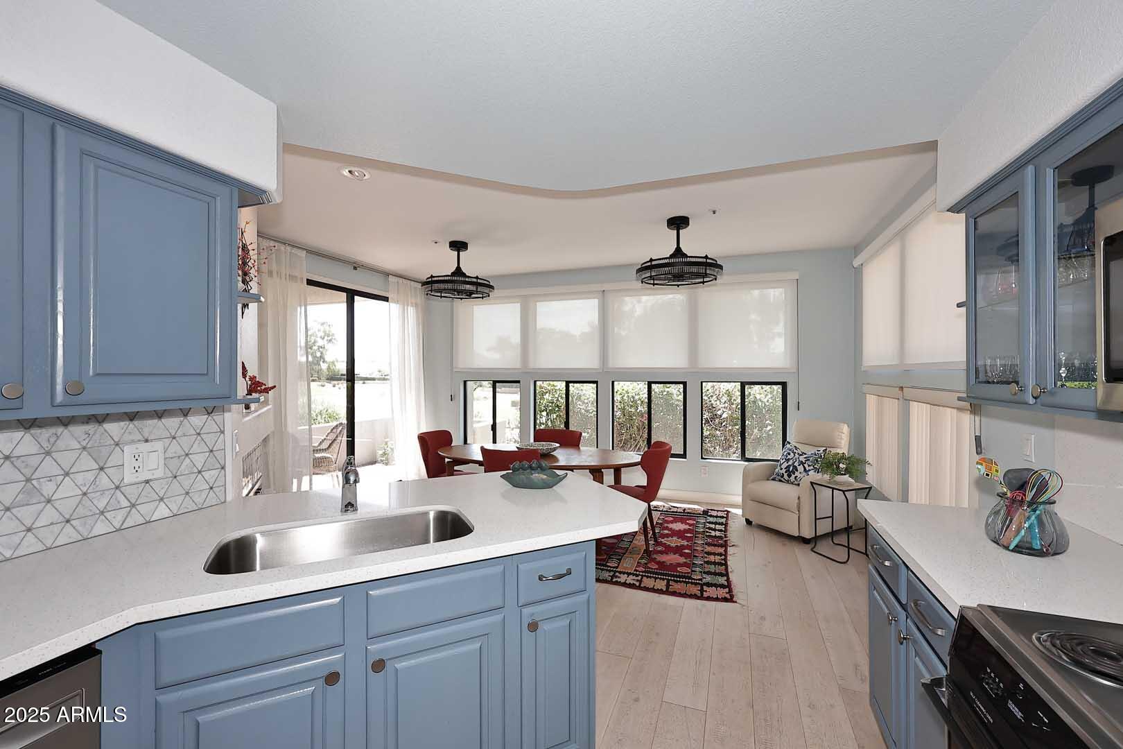7700 East Gainey Ranch Road, Unit 128 Scottsdale, AZ 85258 - Photo 9 of 60 a kitchen with a large window and cabinets