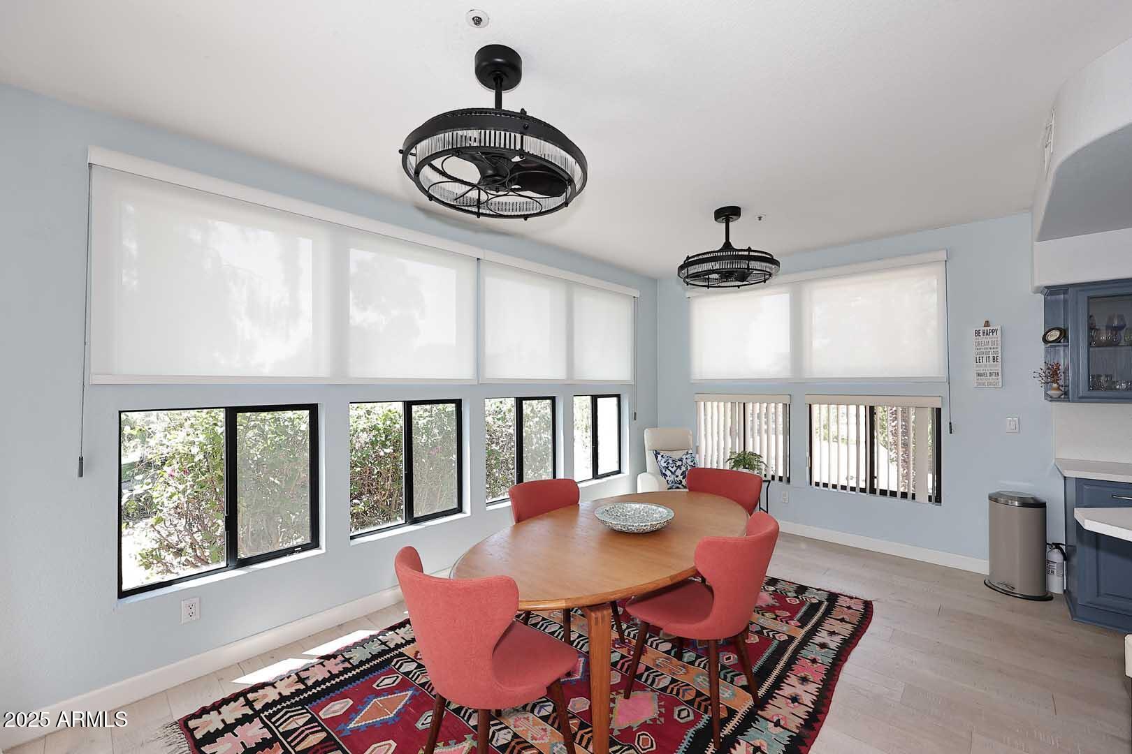 7700 East Gainey Ranch Road, Unit 128 Scottsdale, AZ 85258 - Photo 10 of 60 a view of a dining room with furniture window and wooden floor