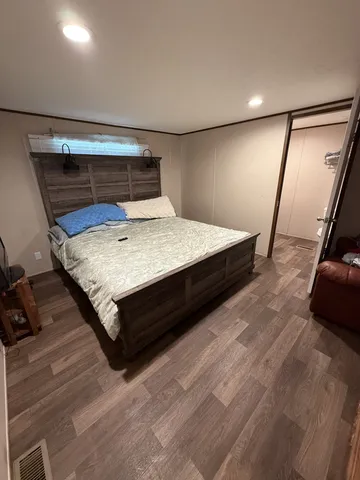 a bed room with a bed and a mirror
