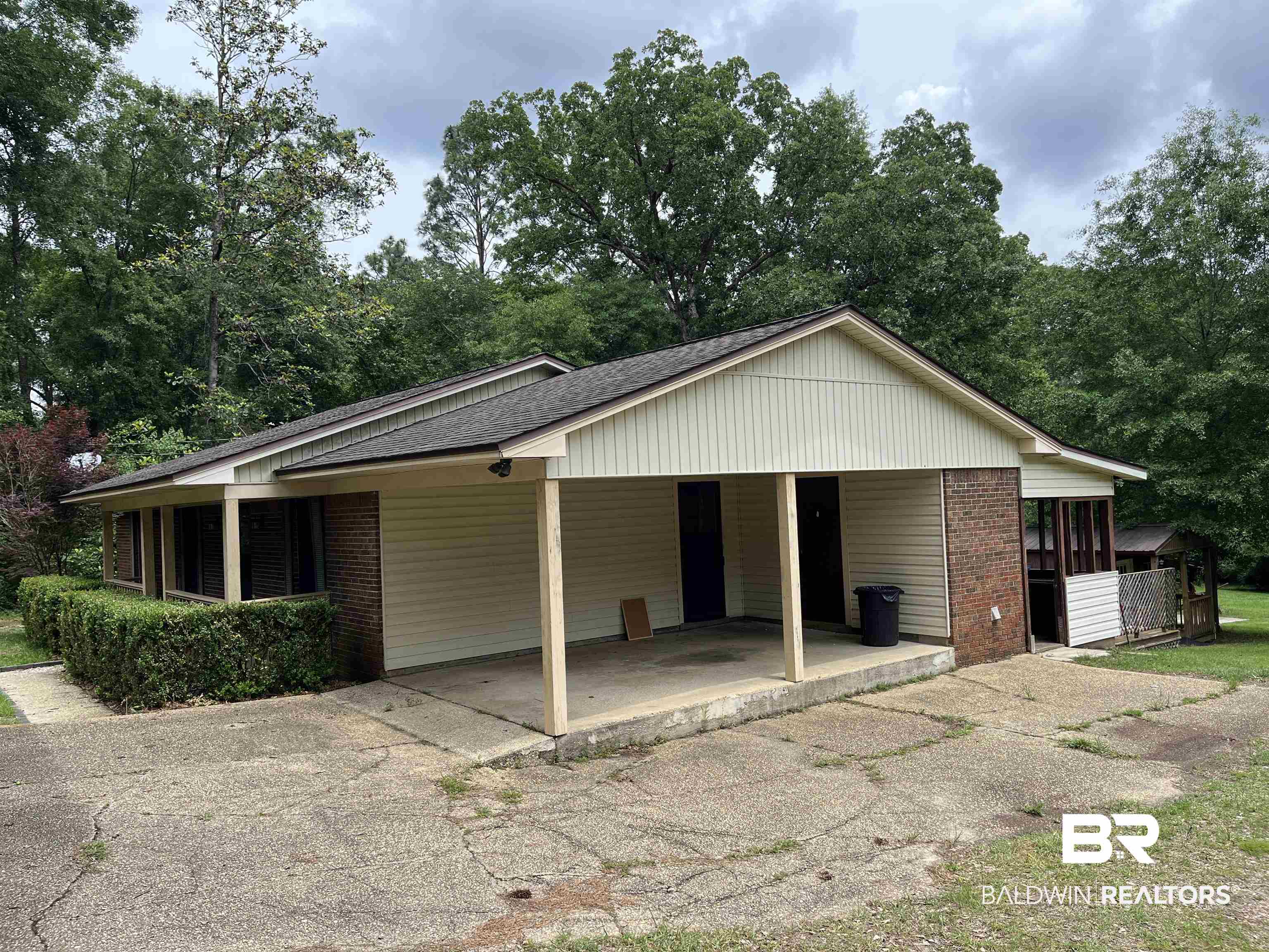 1905 Rockaway Creek Road Atmore, AL 36502 - Photo 2 of 23 Ranch-style exterior with a covered carport, brick accents, and light-toned siding