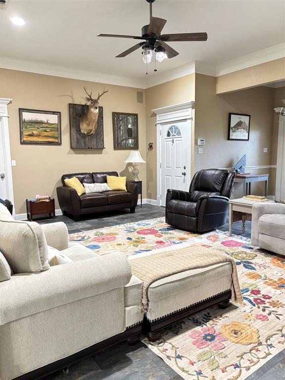605 Jade Haughton, LA 71037 - Photo 4 of 34 Spacious living area featuring dark wood-finish flooring, a ceiling fan with integrated lighting, and crown molding