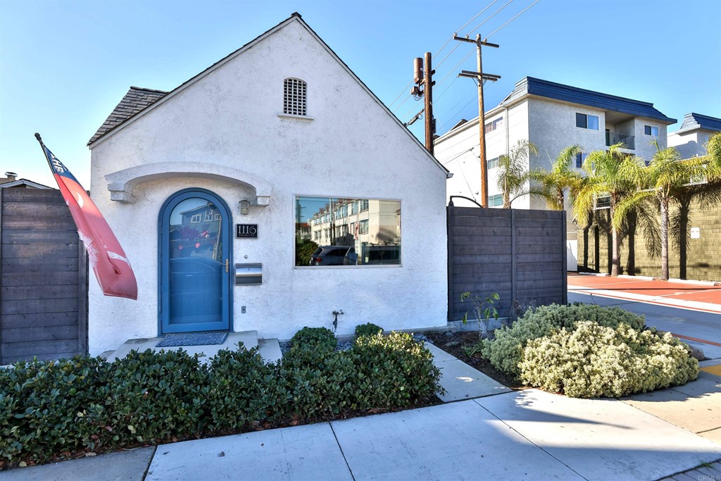 1116 Third Street Coronado, CA 92118 - Photo 2 of 33 a front view of a house with garden