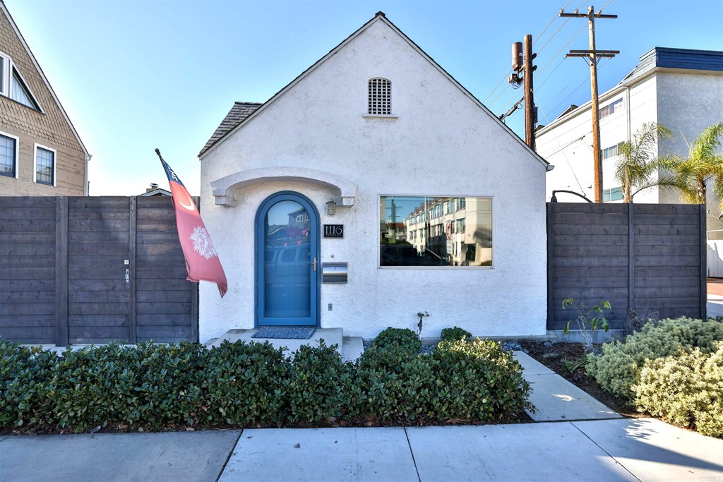 1116 Third Street Coronado, CA 92118 - Photo 3 of 33 a front view of a house with garden