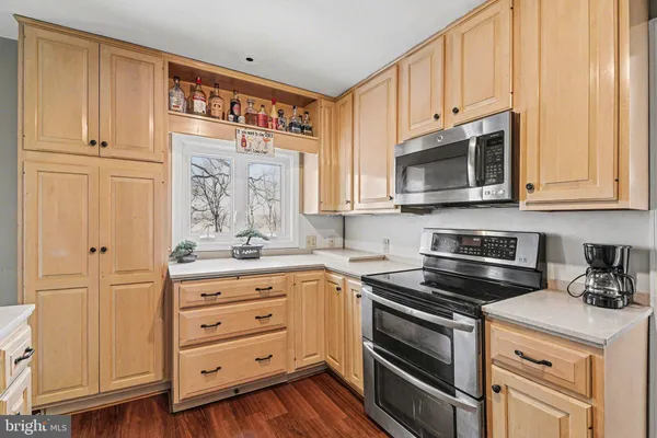 a kitchen with granite countertop cabinets stainless steel appliances and a sink