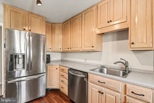 a kitchen with stainless steel appliances granite countertop a refrigerator sink and cabinets