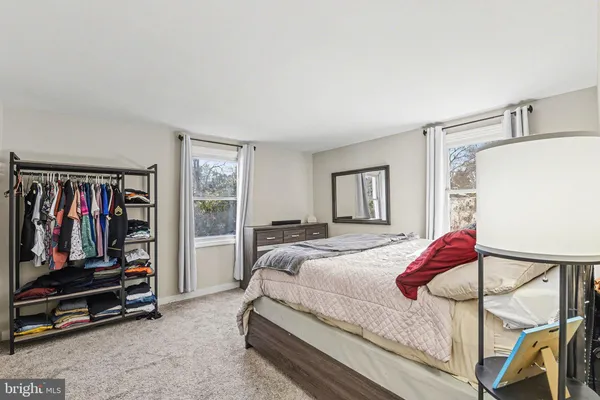 a bedroom with a bed next to a window