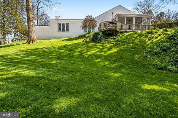 a view of a dinning table and chairs in backyard of the house