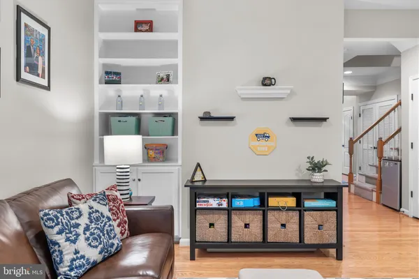 a kitchen with stainless steel appliances granite countertop a refrigerator a sink dishwasher a s stove top oven a large island with cabinets and wooden floor