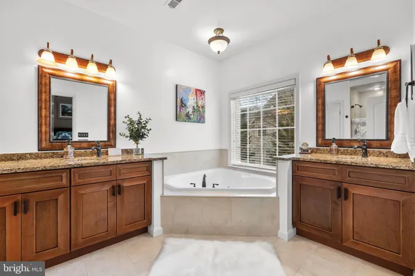 a bathroom with a sink a toilet a mirror and shower curtain