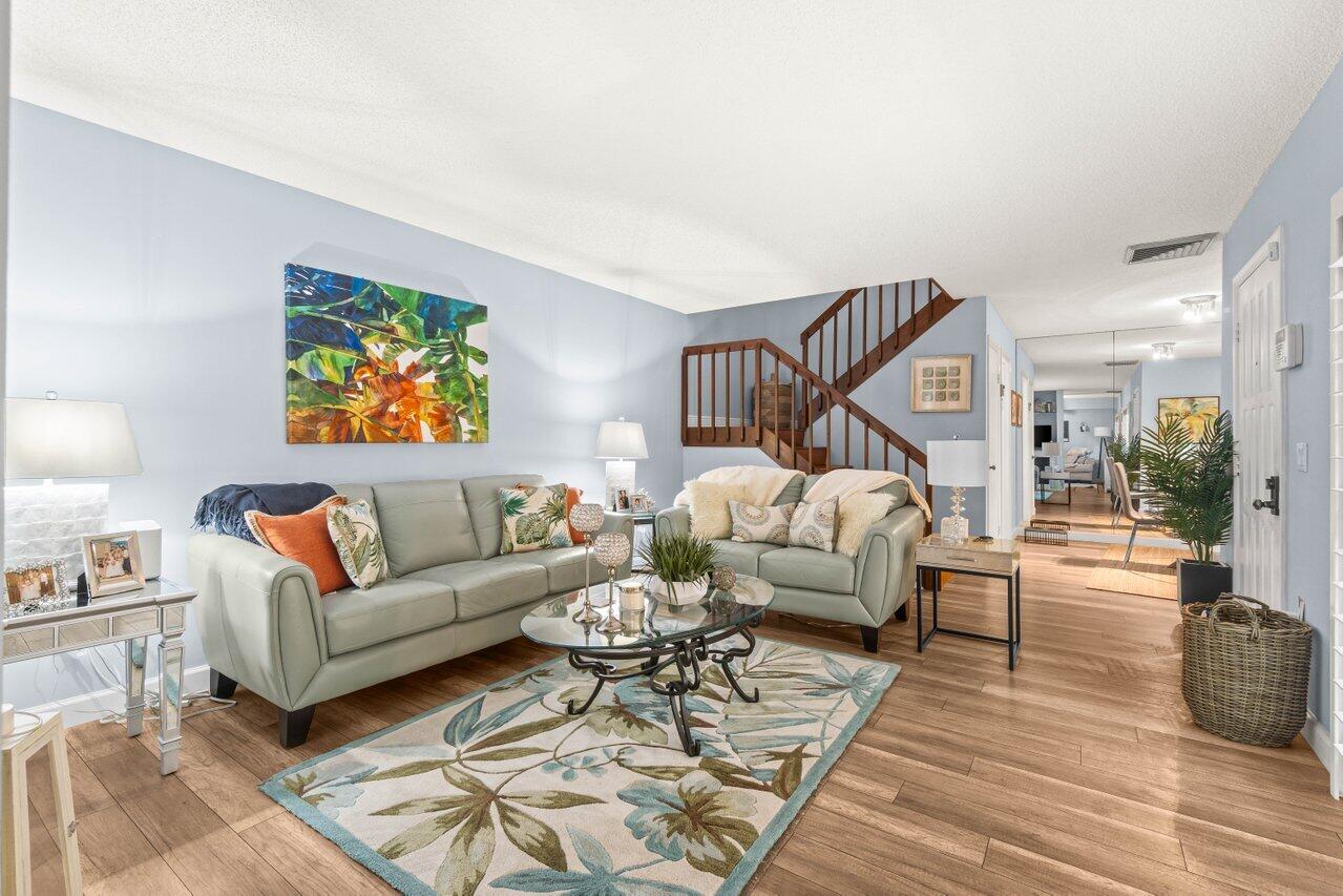 a living room with furniture or couch and a wooden floor