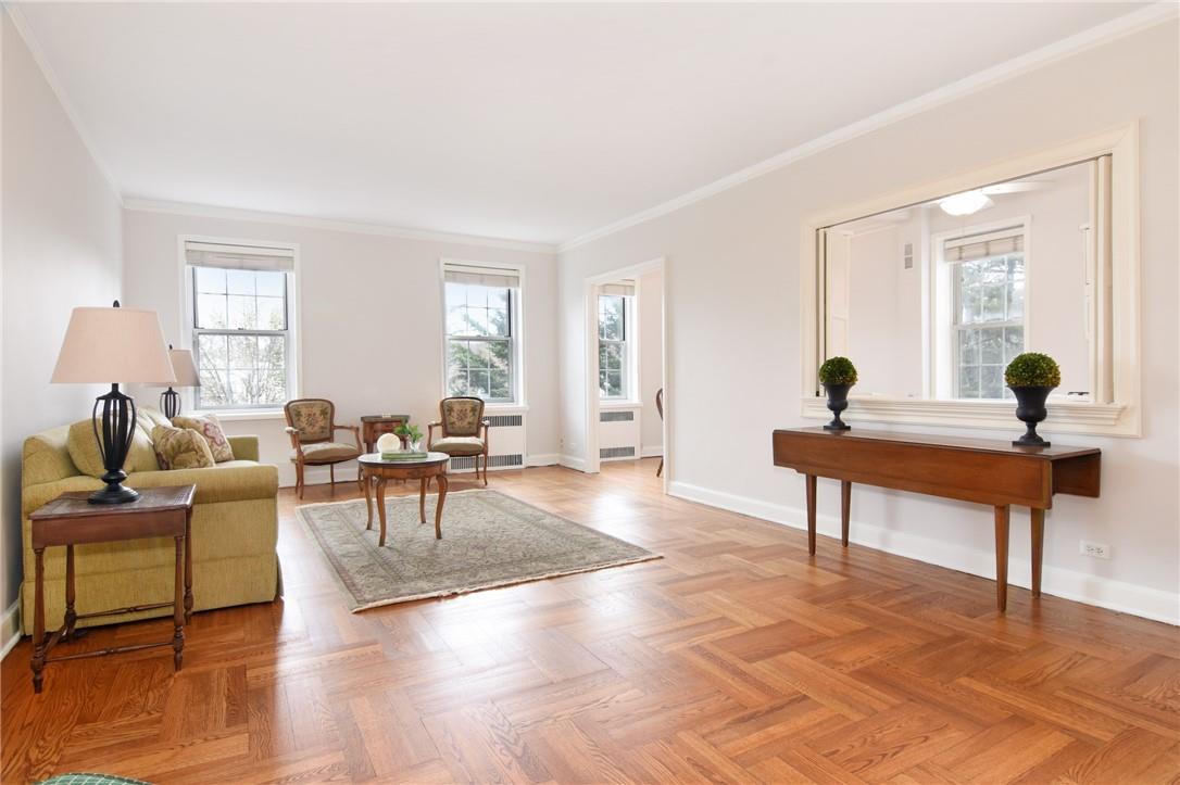 9 Midland Gardens, Unit 3D Bronxville, NY 10708 - Photo 1 of 1 a living room with furniture a window and a table