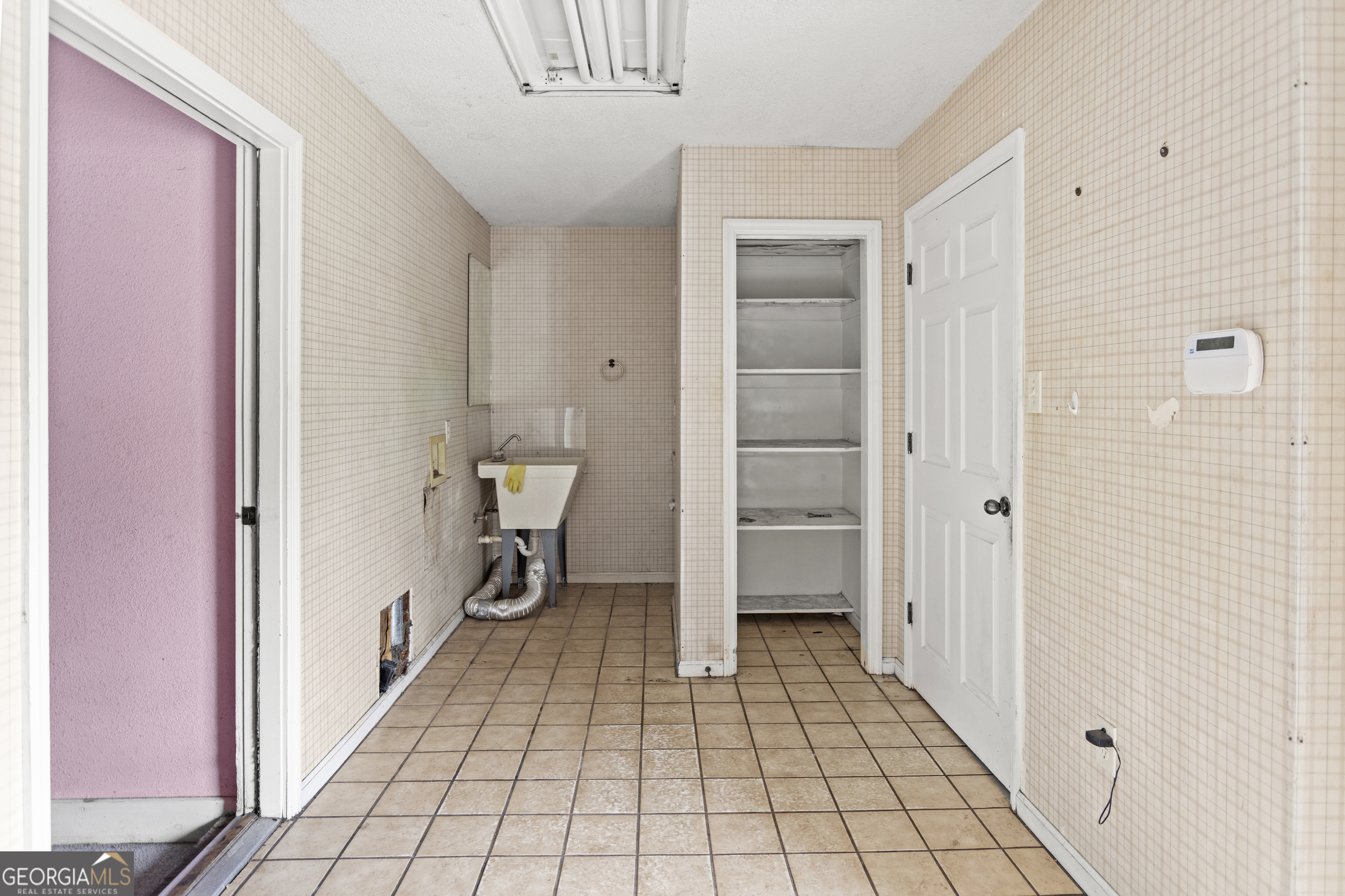 160 Hall Street Hinesville, GA 31313 - Photo 11 of 34 a view of a hallway with closet and cabinet
