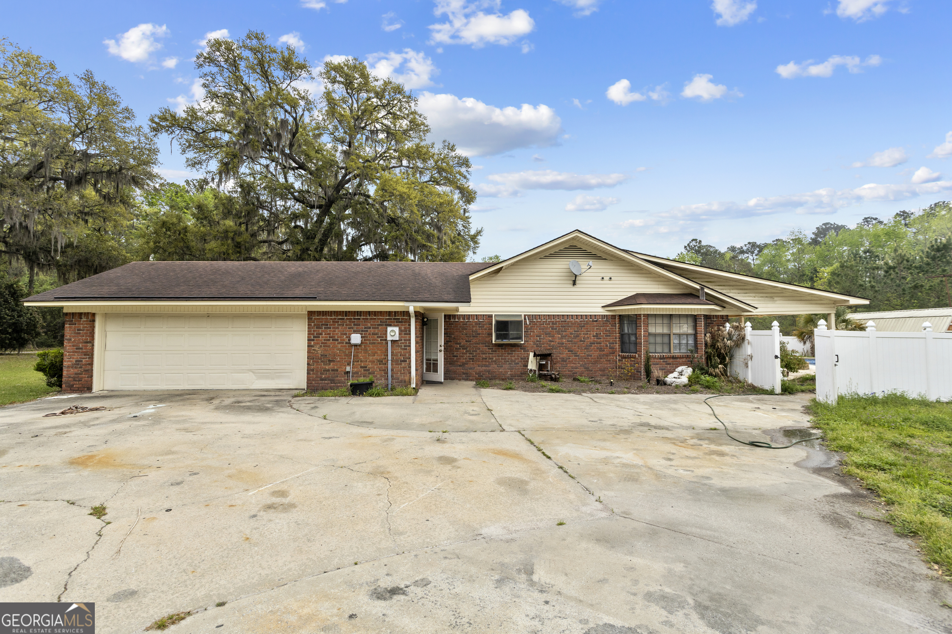 160 Hall Street Hinesville, GA 31313 - Photo 2 of 34 a front view of a house with a yard and garage