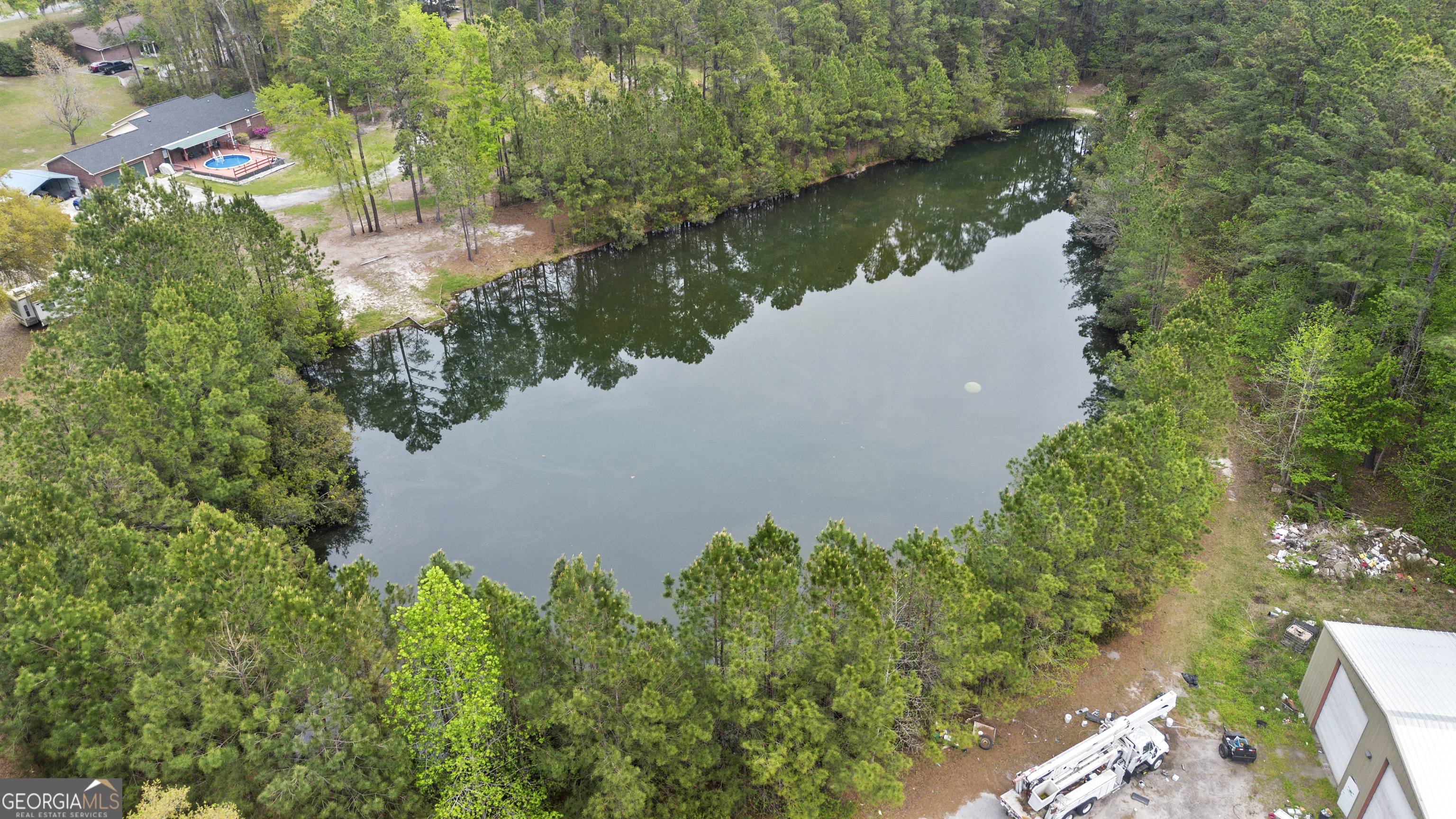 160 Hall Street Hinesville, GA 31313 - Photo 33 of 34 an aerial view of a house with a yard and a large trees all around