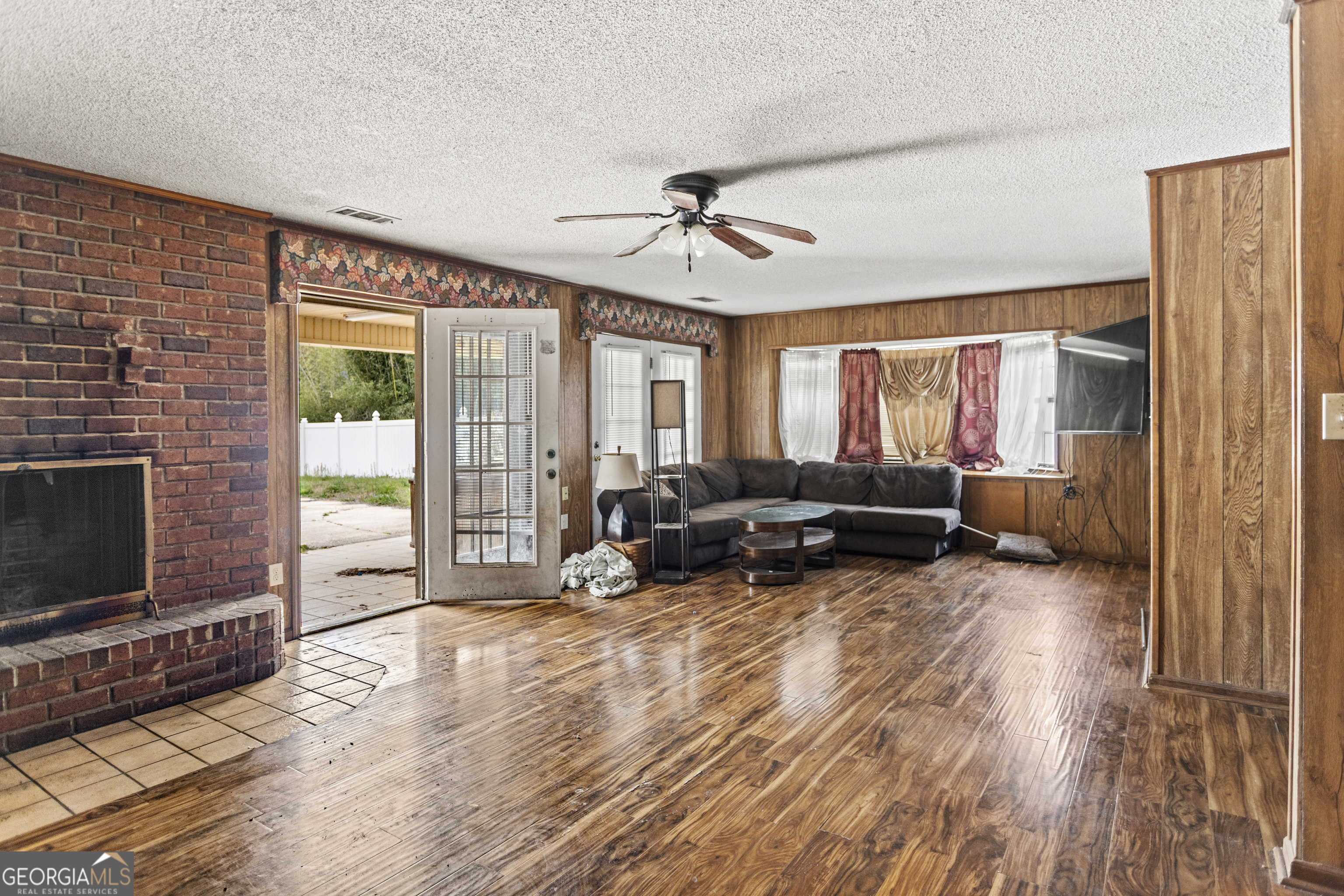 160 Hall Street Hinesville, GA 31313 - Photo 4 of 34 a living room with furniture flat screen tv and a fireplace
