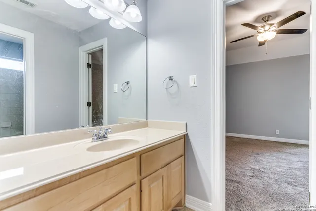 a bathroom with a sink a light fixture and a mirror