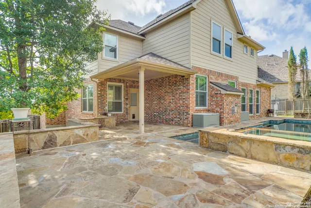 a view of a white house with swimming pool in front of it