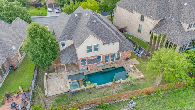 an aerial view of a house with a yard