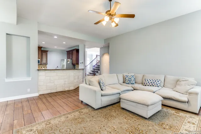 a living room with furniture and a chandelier