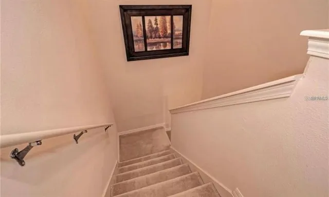 a view of staircase with white walls