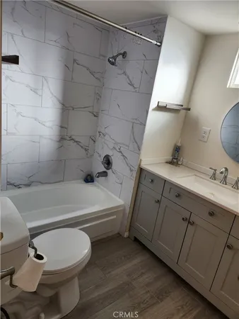 a bathroom with a toilet a sink and bathtub