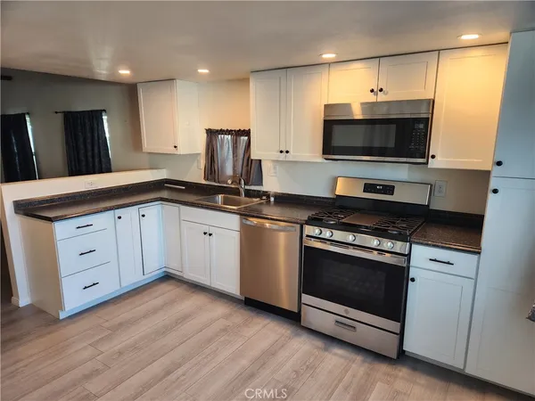 a kitchen with a sink stove and microwave