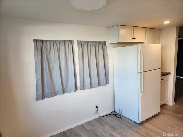 a view of a kitchen with wooden floor