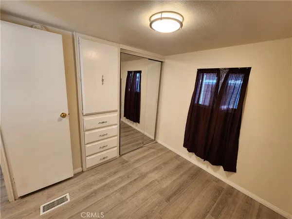 an empty room with wooden floor