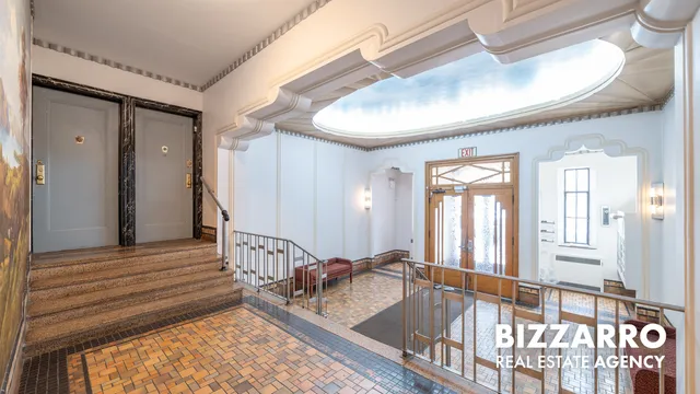 a bathroom with bathtub windows and a chandelier