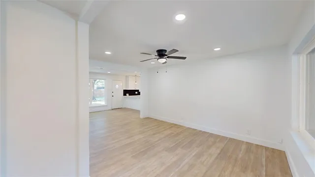 a view of a kitchen with a sink and a refrigerator