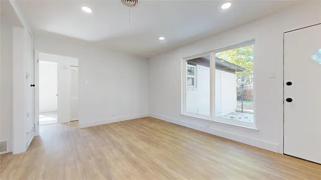 wooden floor in an empty room with a window