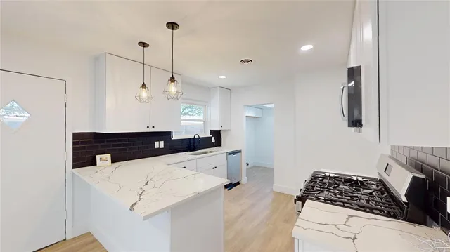 a kitchen with a sink a stove and refrigerator