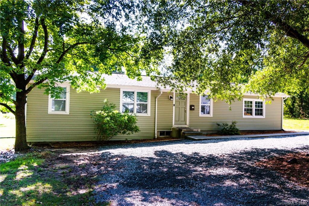 1239 Log Cabin Road Charlotte, NC 28213 - Photo 1 of 26 a front view of a house with a garden