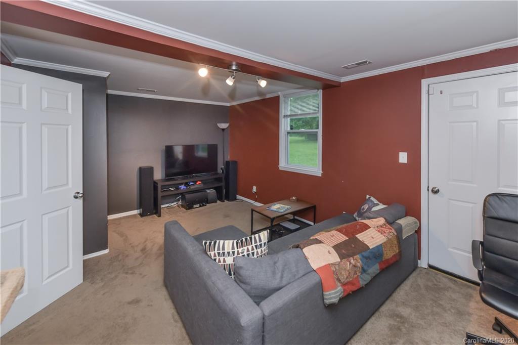 1239 Log Cabin Road Charlotte, NC 28213 - Photo 11 of 26 a living room with furniture and a flat screen tv
