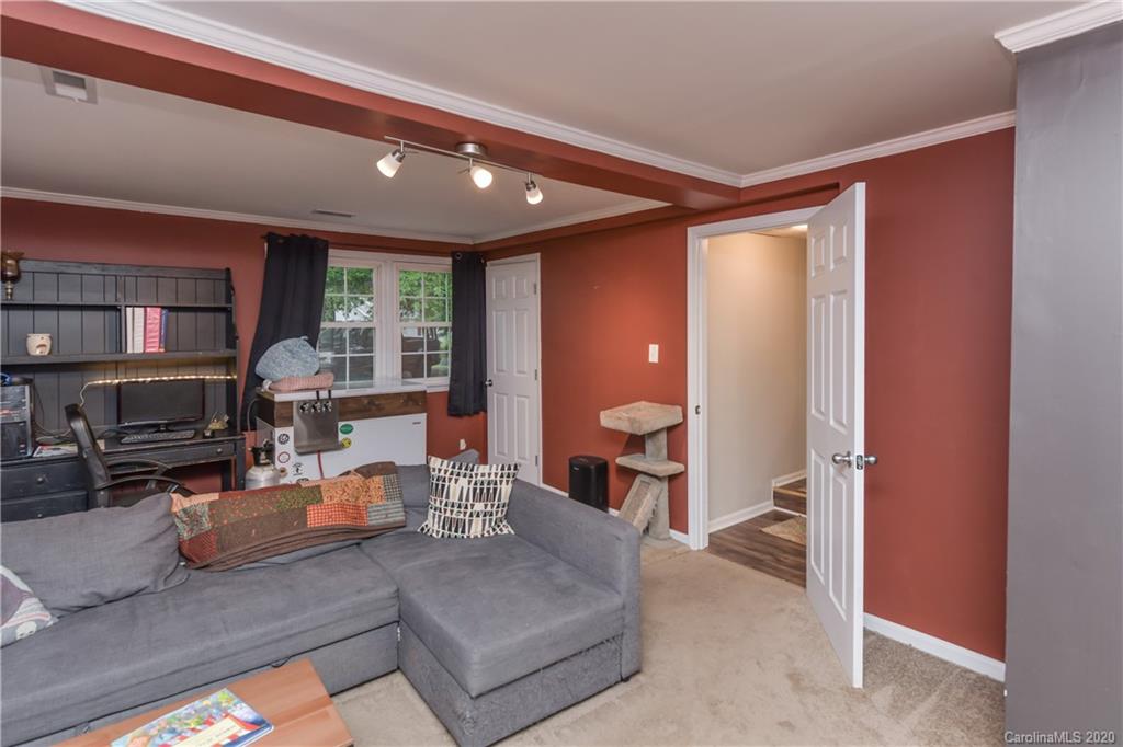 1239 Log Cabin Road Charlotte, NC 28213 - Photo 12 of 26 a living room with furniture and a toilet