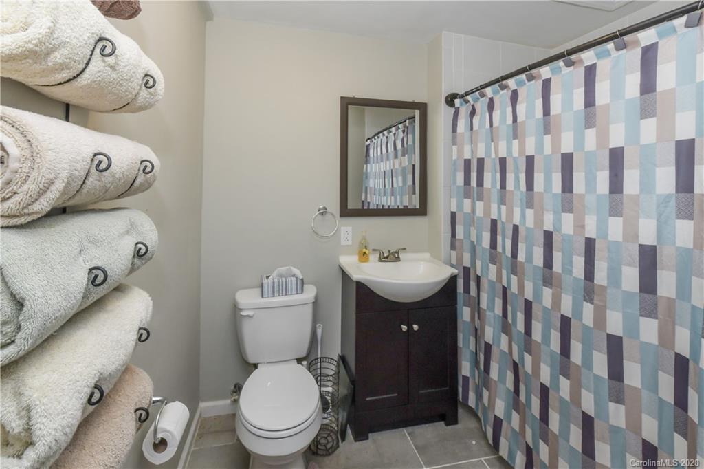 1239 Log Cabin Road Charlotte, NC 28213 - Photo 14 of 26 a bathroom with a toilet sink and mirror