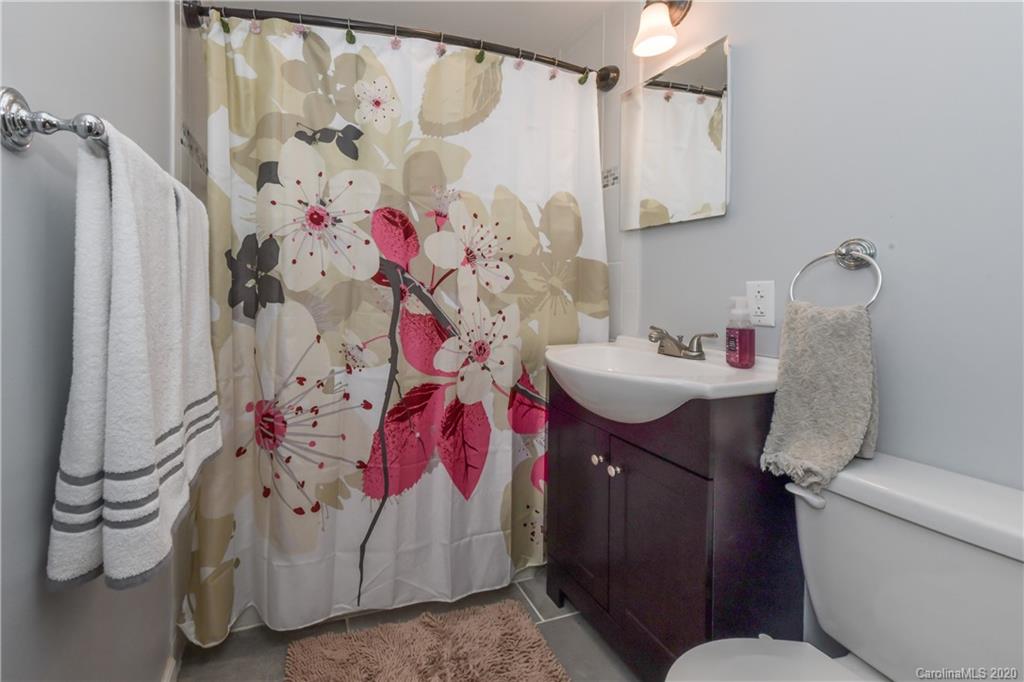 1239 Log Cabin Road Charlotte, NC 28213 - Photo 18 of 26 a bathroom with a sink toilet and shower curtain