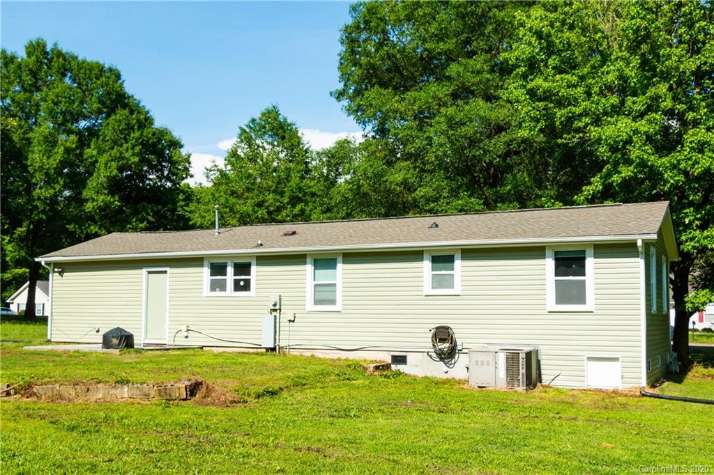 1239 Log Cabin Road Charlotte, NC 28213 - Photo 20 of 26 a front view of a house with a yard