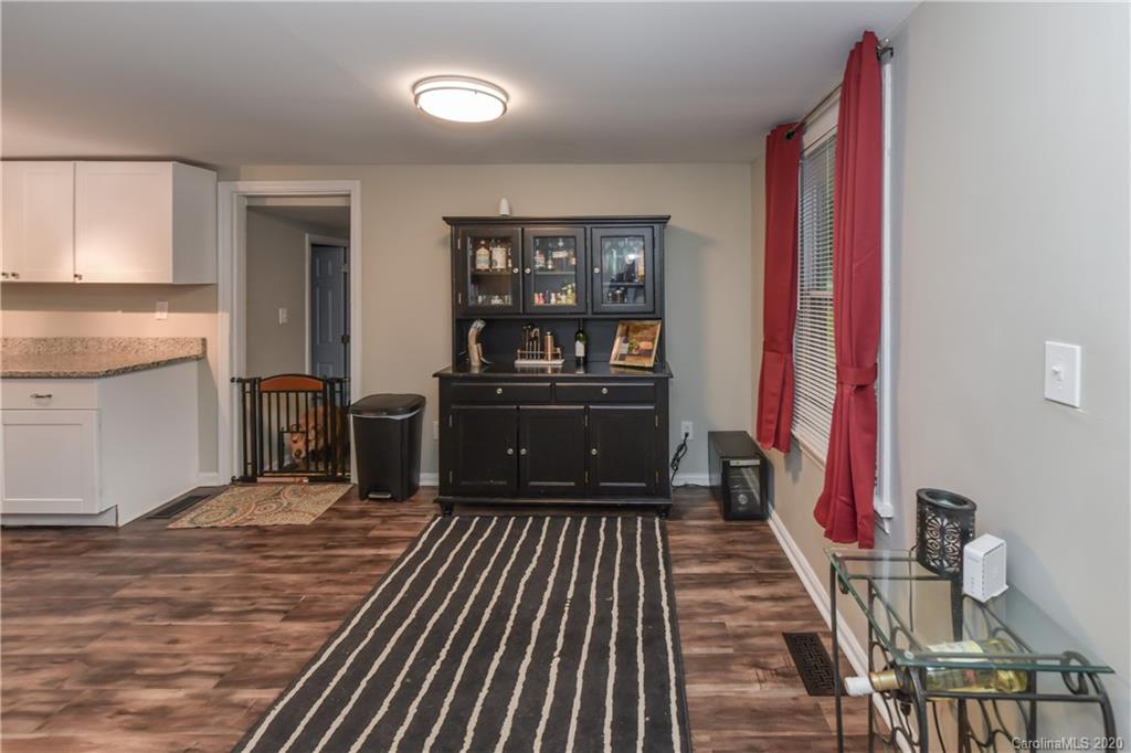 1239 Log Cabin Road Charlotte, NC 28213 - Photo 4 of 26 a living room with stainless steel appliances furniture a rug and a kitchen view